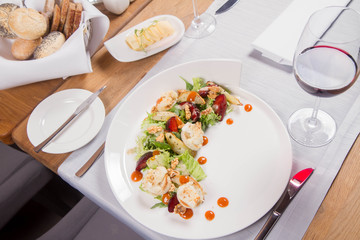 Starter: Mix salads, baked goat cheese, sea-buckthorn jam, caramelized pear with thyme, plum and roast nuts - served in a restaurant