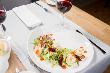 Starter: Mix salads, baked goat cheese, sea-buckthorn jam, caramelized pear with thyme, plum and roast nuts - served in a restaurant