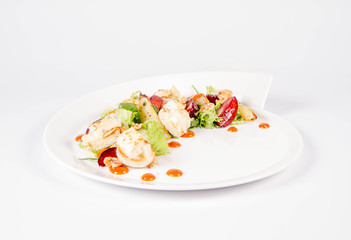 Starter: Mix salads, baked goat cheese, sea-buckthorn jam, caramelized pear with thyme, plum and roast nuts - on a white background