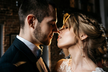 Beautiful bride and groom kiss