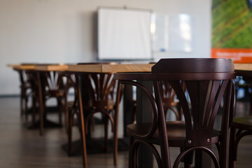 Inside the old classroom with blackboard, desks and chairs.