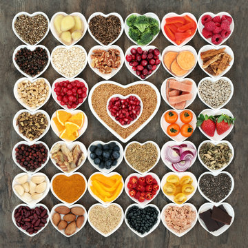 Health food for a healthy heart with vegetables, fruit, fish, nuts, seeds, grain, cereals with herbs and spices  used in herbal medicine. High in omega 3 fatty acids, fibre, antioxidants and minerals 