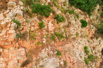 Aerial view on the texture of the rock of red color. The village of Rezevici, on the coast of Montenegro.