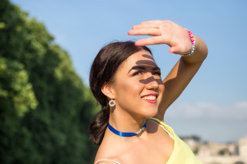 Tourist attractive woman enjoy her holiday in Rome and look at the sun