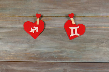 Sagittarius and twins. signs of the zodiac and heart. wooden bac