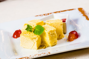 Indian sweet dessert. Soan Papdi on white plate