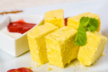 Indian sweet dessert. Soan Papdi on white plate