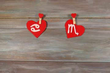 Cancer and scorpion. signs of the zodiac and heart. wooden backg