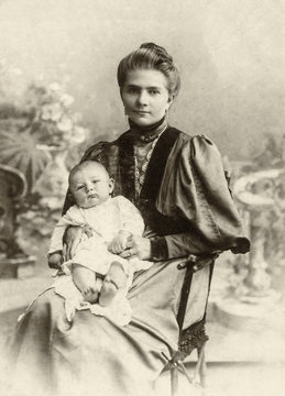 Vintage photo of the Russian woman with the small child on hands, the beginning of the 20th century