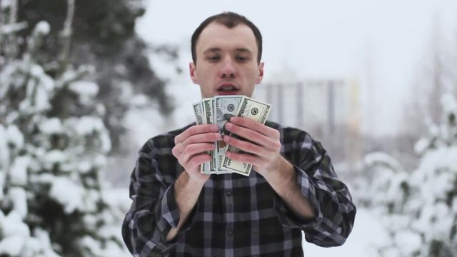 a man with dolor bills in his hands