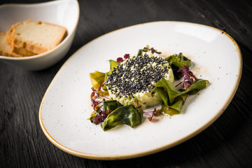 Tartar of zucchini and avocado, wakame algaeand black sesame with hazelnut oil