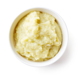 Cauliflower and zucchini baby puree isolated on white