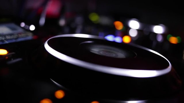 Dj hands playing and mixing music in a nightclub