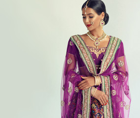Portrait of beautiful indian girl. Young hindu woman model with kundan jewelry set. Traditional...