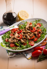 chicken salad with arugula ,tomatoes and balsamic vinegar,selective focus