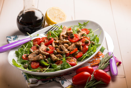 chicken salad with arugula ,tomatoes and balsamic vinegar,selective focus