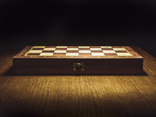 close up shot of the closed chess board isolated on the table