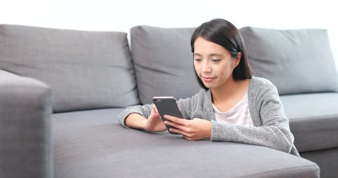 Woman using cellphone at home