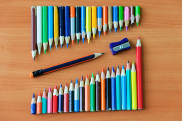 Naklejka premium Color pencils for children's creativity on a wooden background