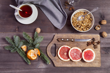 the Set for mulled wine: sliced grapefruit with anise on the board on the wooden brown background.