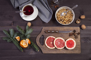 the Set for mulled wine: sliced grapefruit with anise on the board on the wooden brown background.