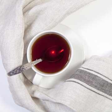 the Cup of tea with spoon on white background