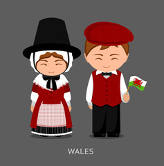 Welsh in national dress with a flag. Man and woman in traditional costume. Travel to Wales. People. Vector flat illustration.