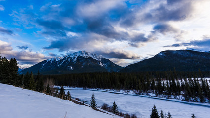 Clouds above rocky mountains overlooking the Bow River