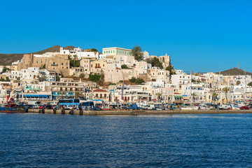 White houses of Naxos (Chora) town and boats in port on Naxos island. Greece © vivoo