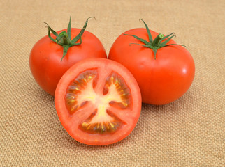 Fresh tomatoes isolated on burlap