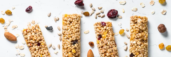 Foto op Plexiglas Granola bar with nuts, fruit and berries on white. © nadianb