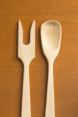 wooden ladle and fork on board
