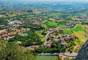 The view from the fortress of San Marino on the mountain and surroundings in a Sunny summer day.