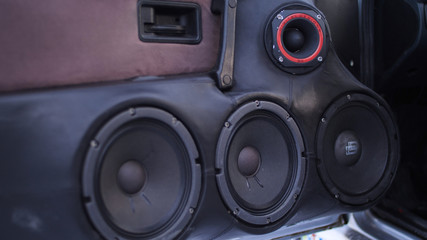 Car audio system close up honeycomb in front door panel,Car radio speaker. Music speakers in the...