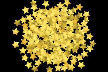 Golden confetti isolated on black background.