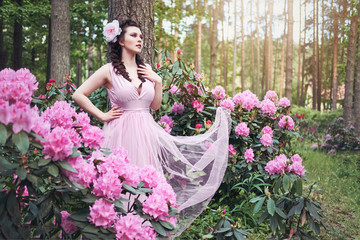 Fototapeta premium girl in dress in rhododendron garden