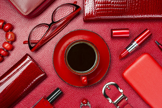 Red woman accessories with coffee, cosmetic, jewelry,  gadget and other objects on leather background, fashion industry, modern female concept, selective focus 