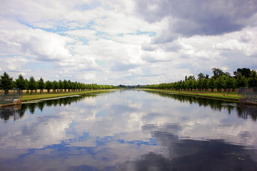 The stunning landscape view of Hampton Court Lake, shot on a cloudy day summers day.