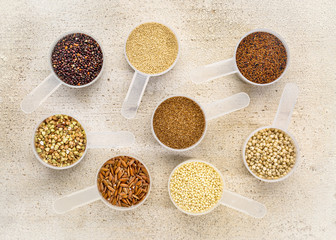 gluten free grains in measuring scoops on wood
