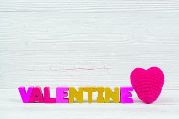 Valentine card with valentine text and red knitting heart on white wooden background and copy space for add text and picture, love and valentine day concept.