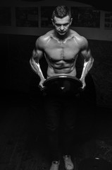 Fototapeta na wymiar bodybuilder athletic guy execute biceps exercise with dumbbellsfitness,