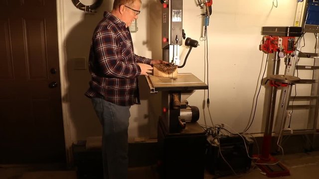Man using a wood-cutting bandsaw to shape a circle for turning a bowl