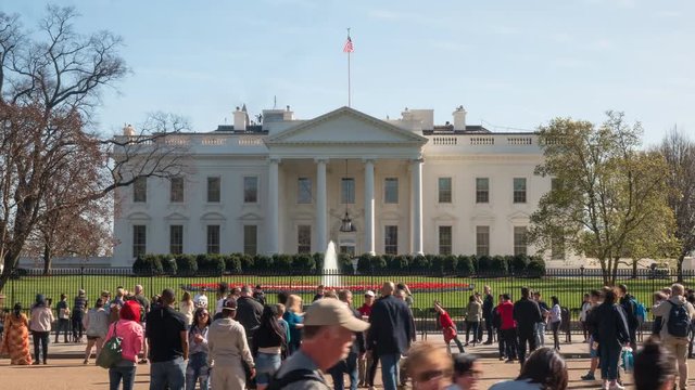 a day time lapse of a crowd of people at the white house in washington dc