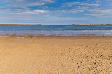 Fototapeta na wymiar Lighthouse and pier at the North Sea coast of Roker Beach in Sunderland, Tyne and Wear, UK