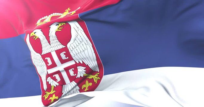 Flag of Serbia waving at wind in slow with blue sky, loop