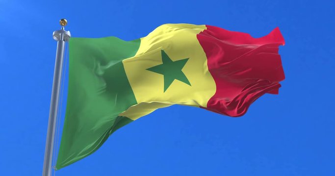 Flag of Senegal waving at wind in slow with blue sky, loop
