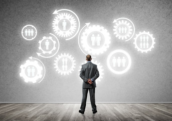 Cogwheel engine drawn on concrete wall as symbol for teamwork and cooperation