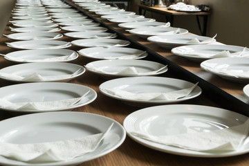 White plates for hotel banquet.