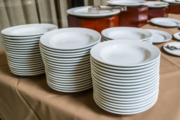 White plates for hotel banquet.