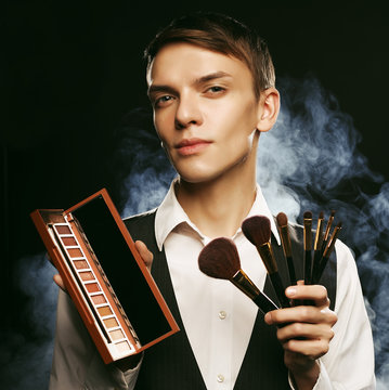 Young Male Make Up Artist Posing With Make-up Brushes And Shadow